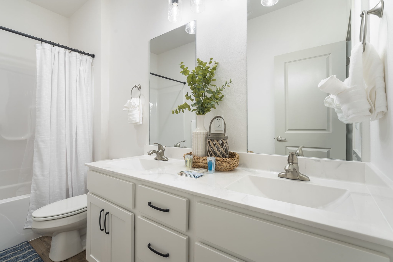 The shared bathroom offers a large double vanity and shower/tub combo