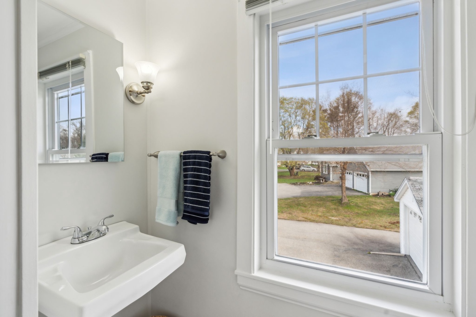 The chic full bath showcases a single vanity & shower/tub combo