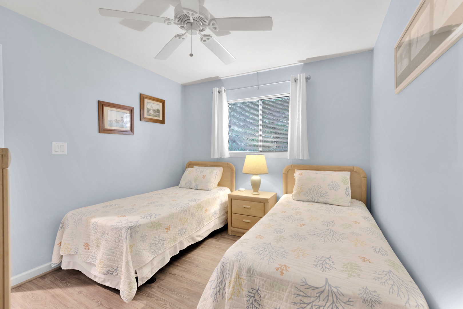 The second bedroom includes a pair of cozy twin beds & Smart TV