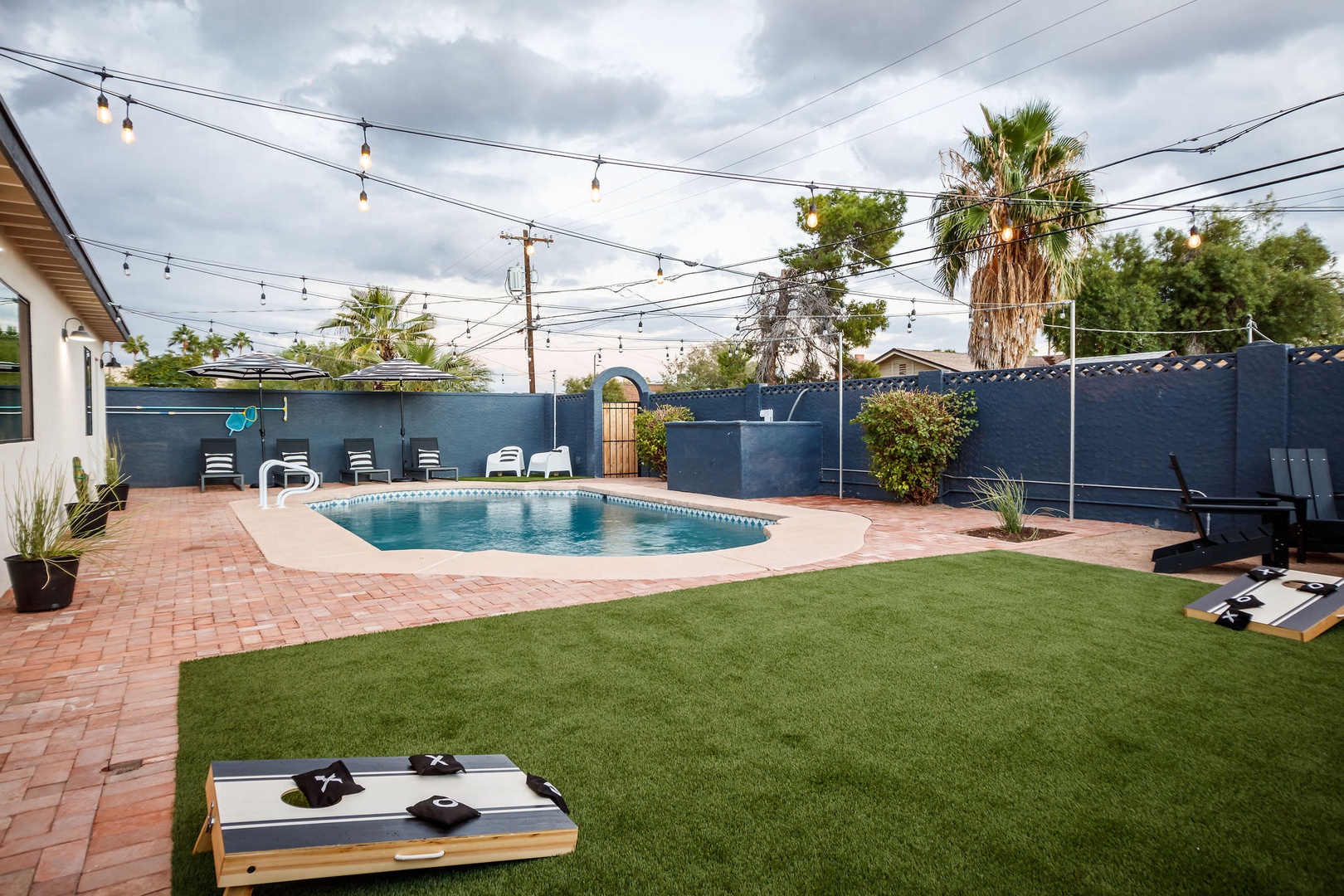 The backyard leaves you in the lap of luxury! Enjoy the pool, lounge areas, or a friendly game of cornhole