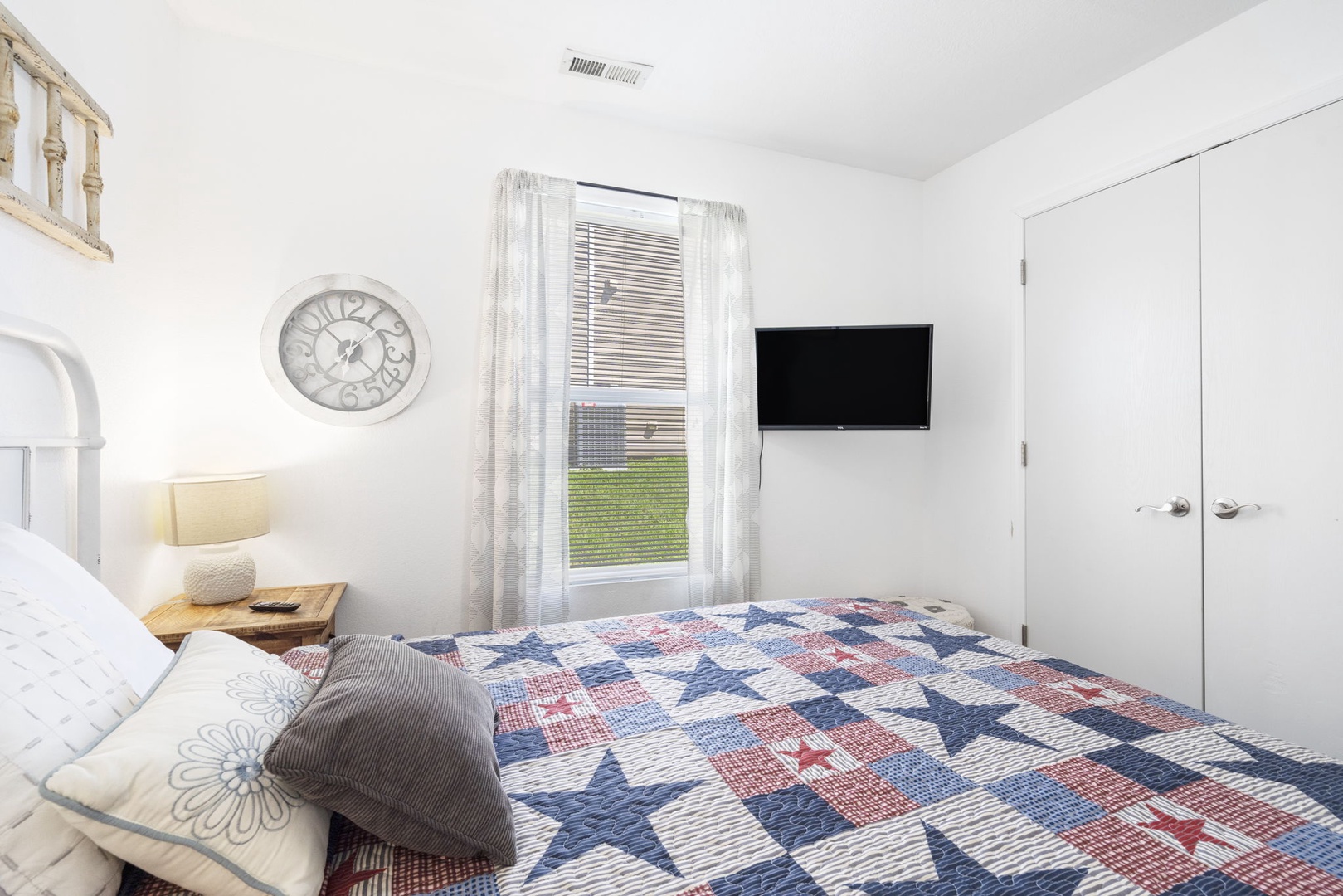 The second bedroom offers guests a queen bed & Smart TV