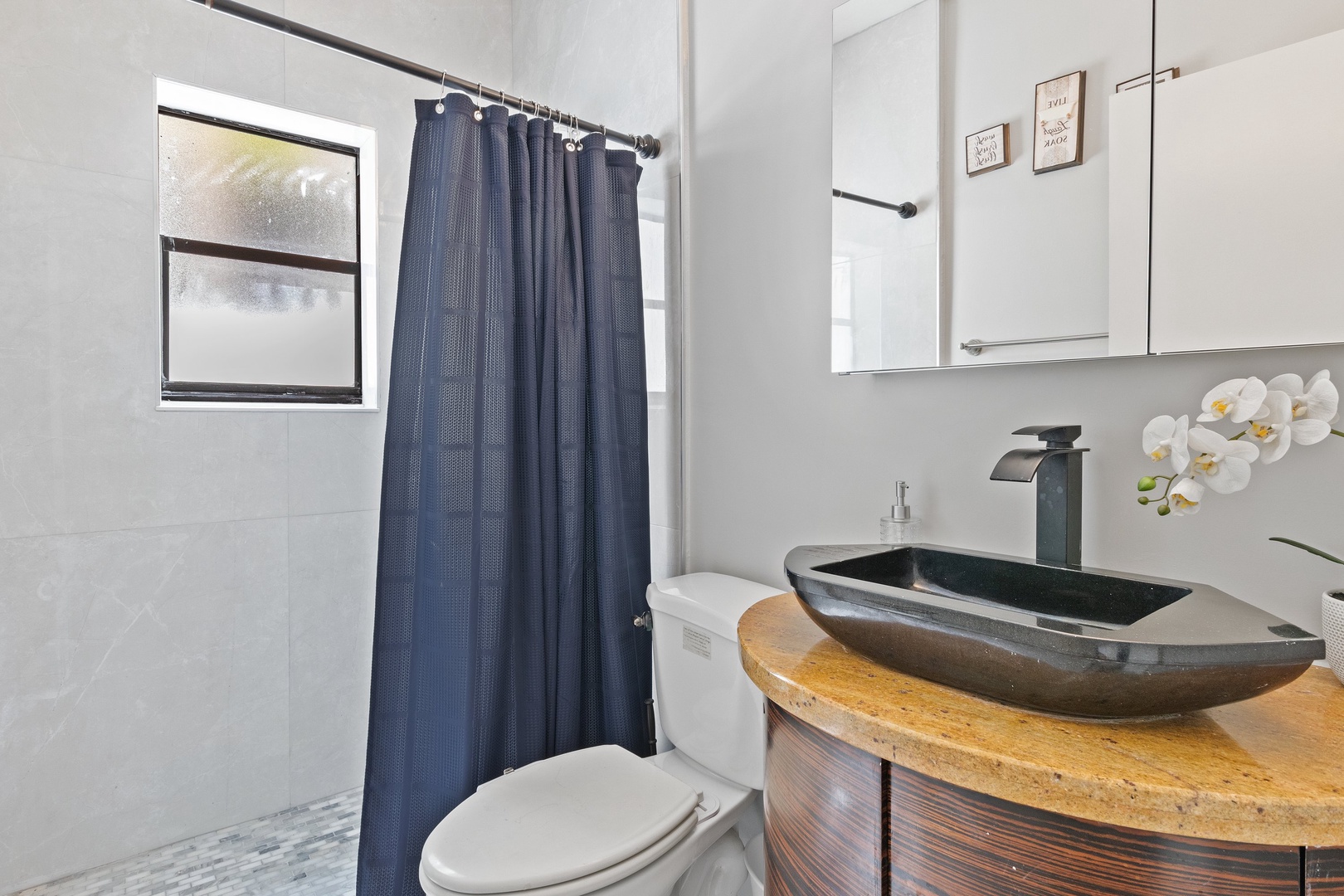 A chic vanity & shower await in the sophisticated full bathroom