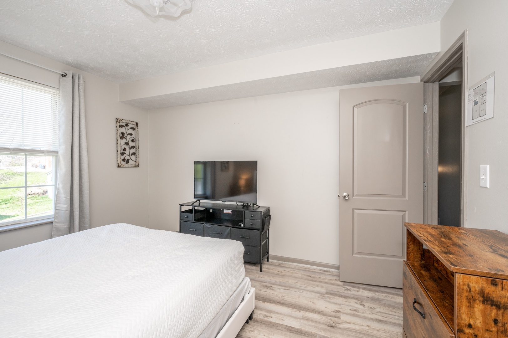 The 1st of 2 bedrooms in Apartment 2 boasts a plush queen bed & Smart TV