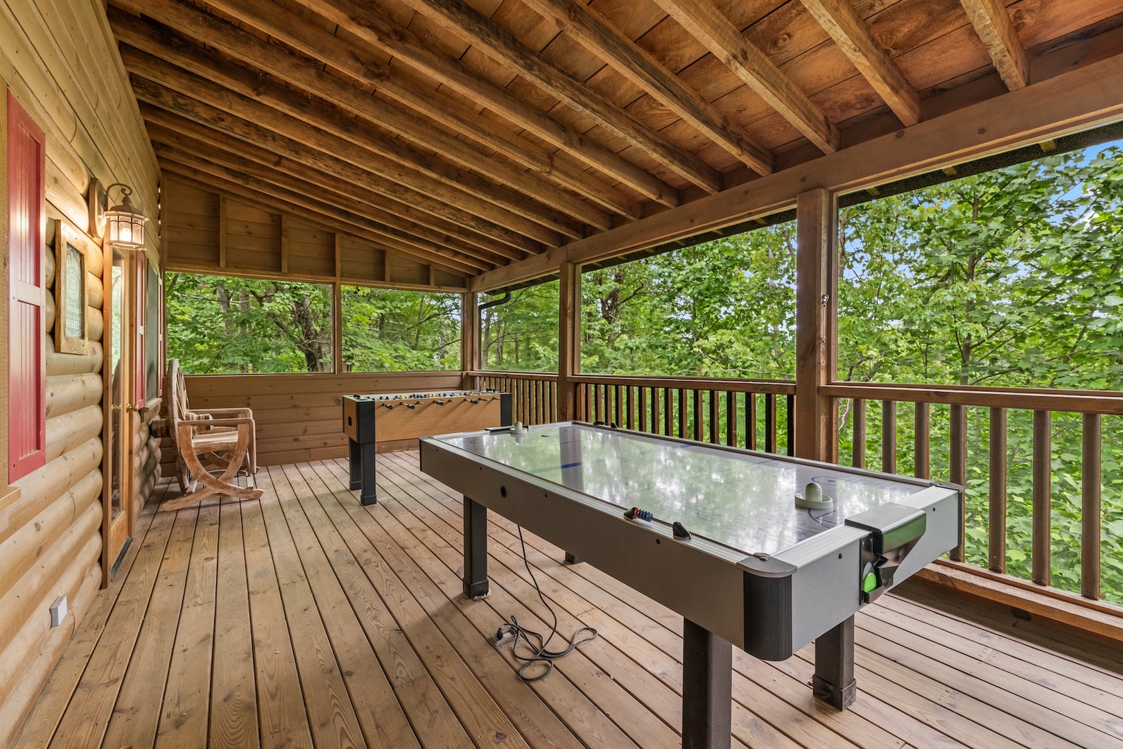 Additional covered deck with outdoor seating, foosball, and air hockey