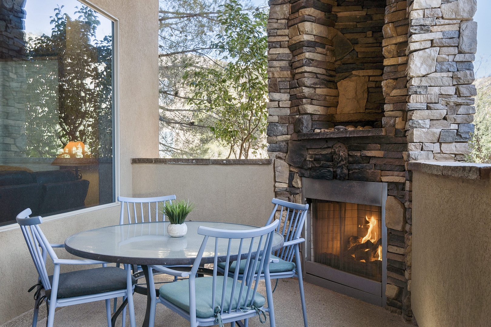 Balcony with outdoor dining and fireplace