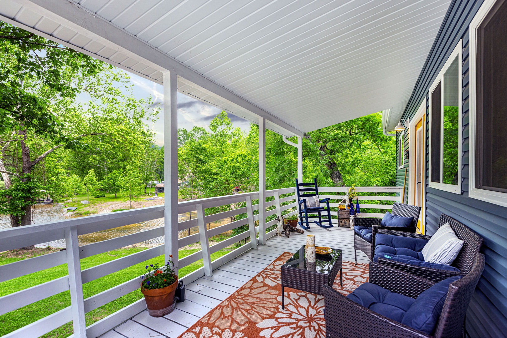 Covered porch with ample seating, grill, and breathtaking views