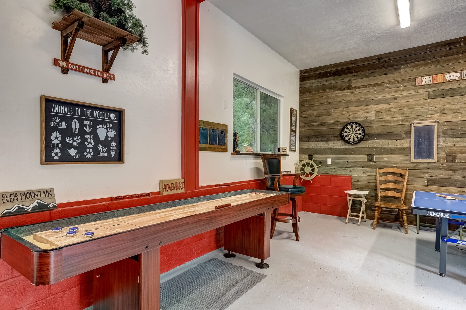 Game room with ping pong table, shuffleboard table, and darts