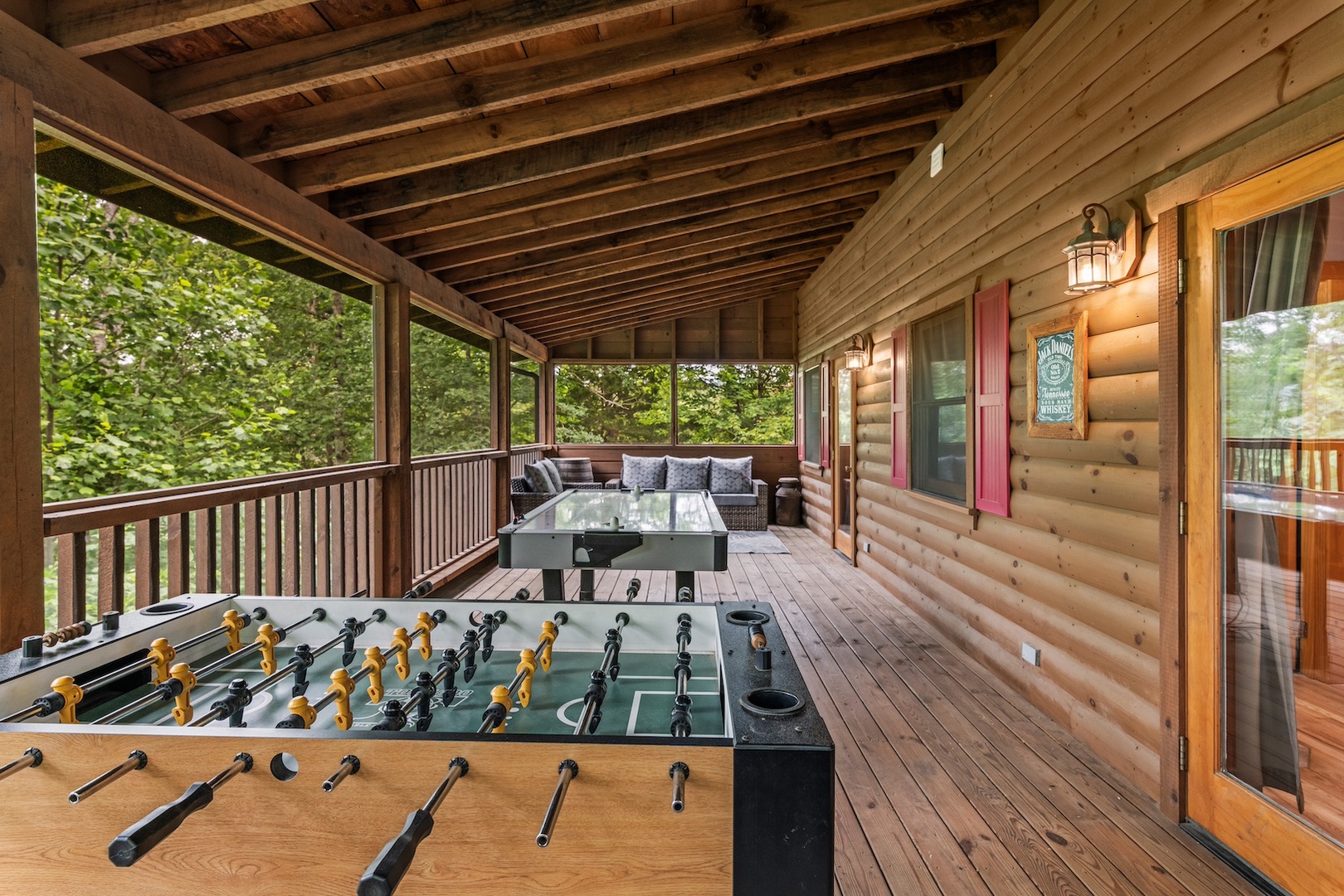 Additional covered deck with outdoor seating, foosball, and air hockey