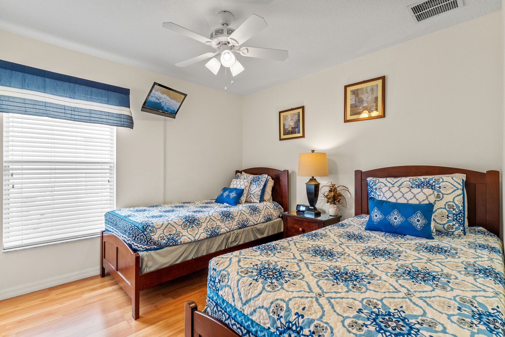 Twin bedroom with two beds and a ceiling fan for enhanced comfort