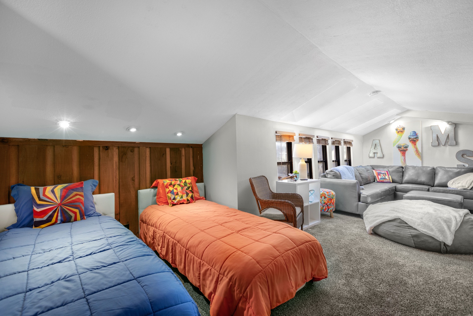 The loft features a pair of twin beds, cozy tv area, and convenient half bath