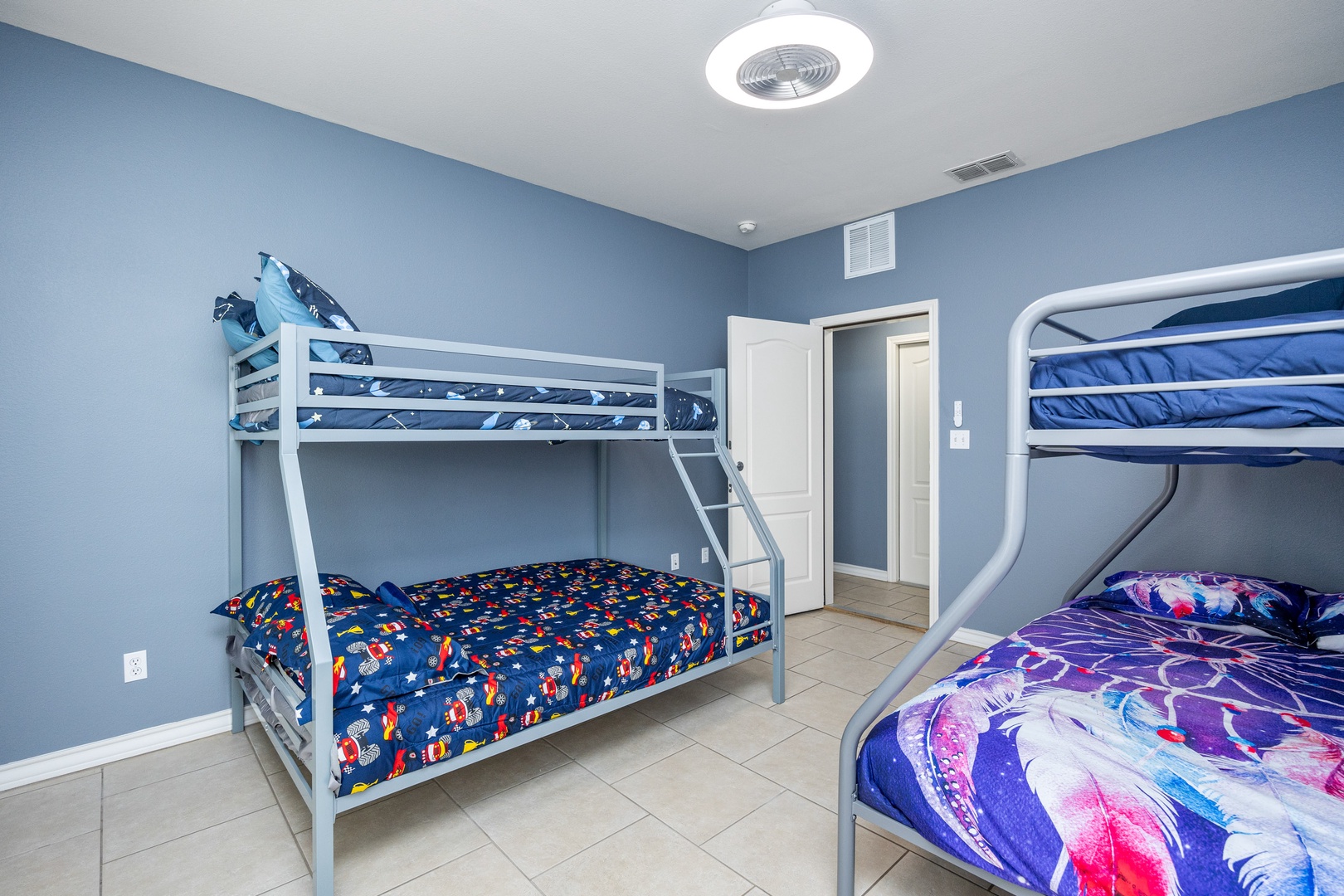 The downstairs bedroom contains two twin over full bunks & patio access