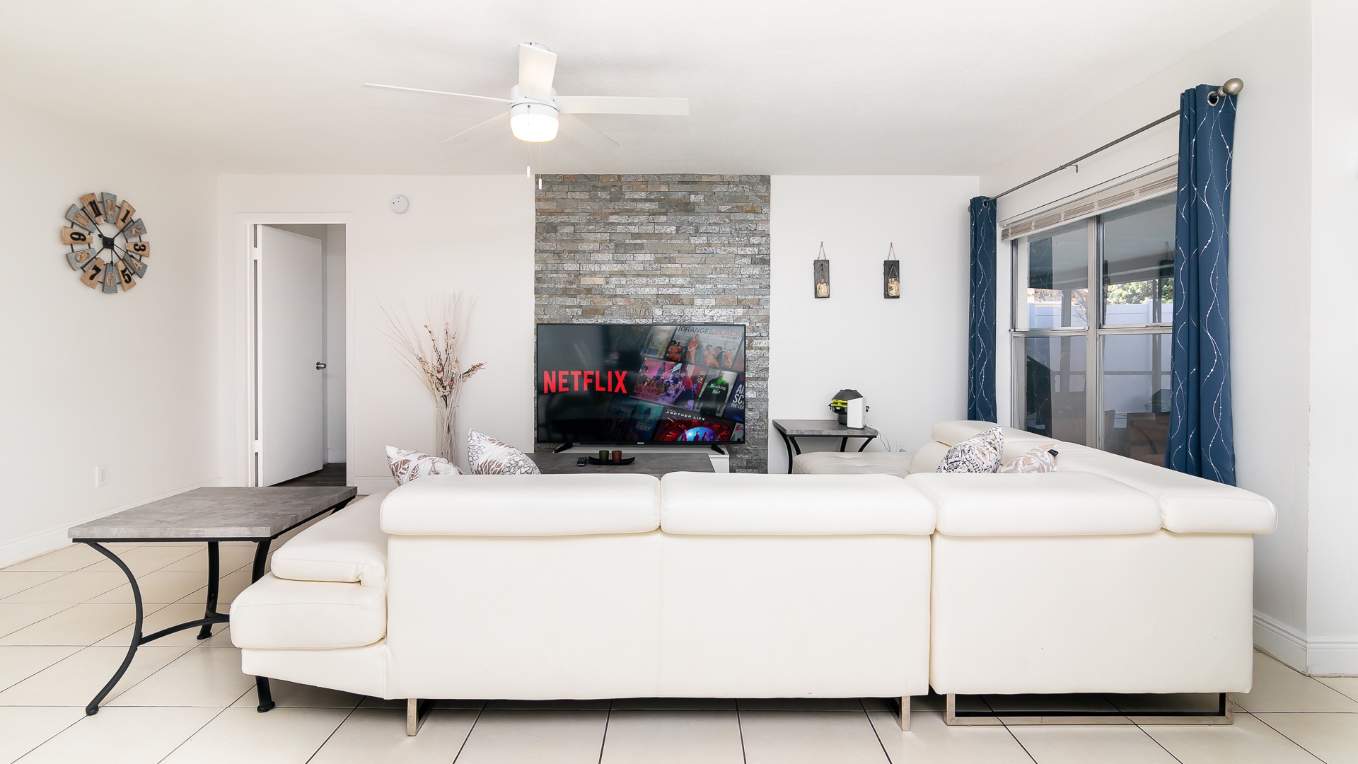 Modern spacious living area with TV