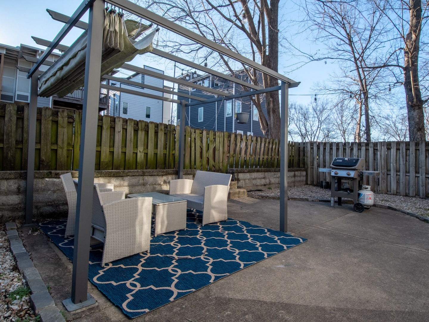 Back private patio with seating area, and grill