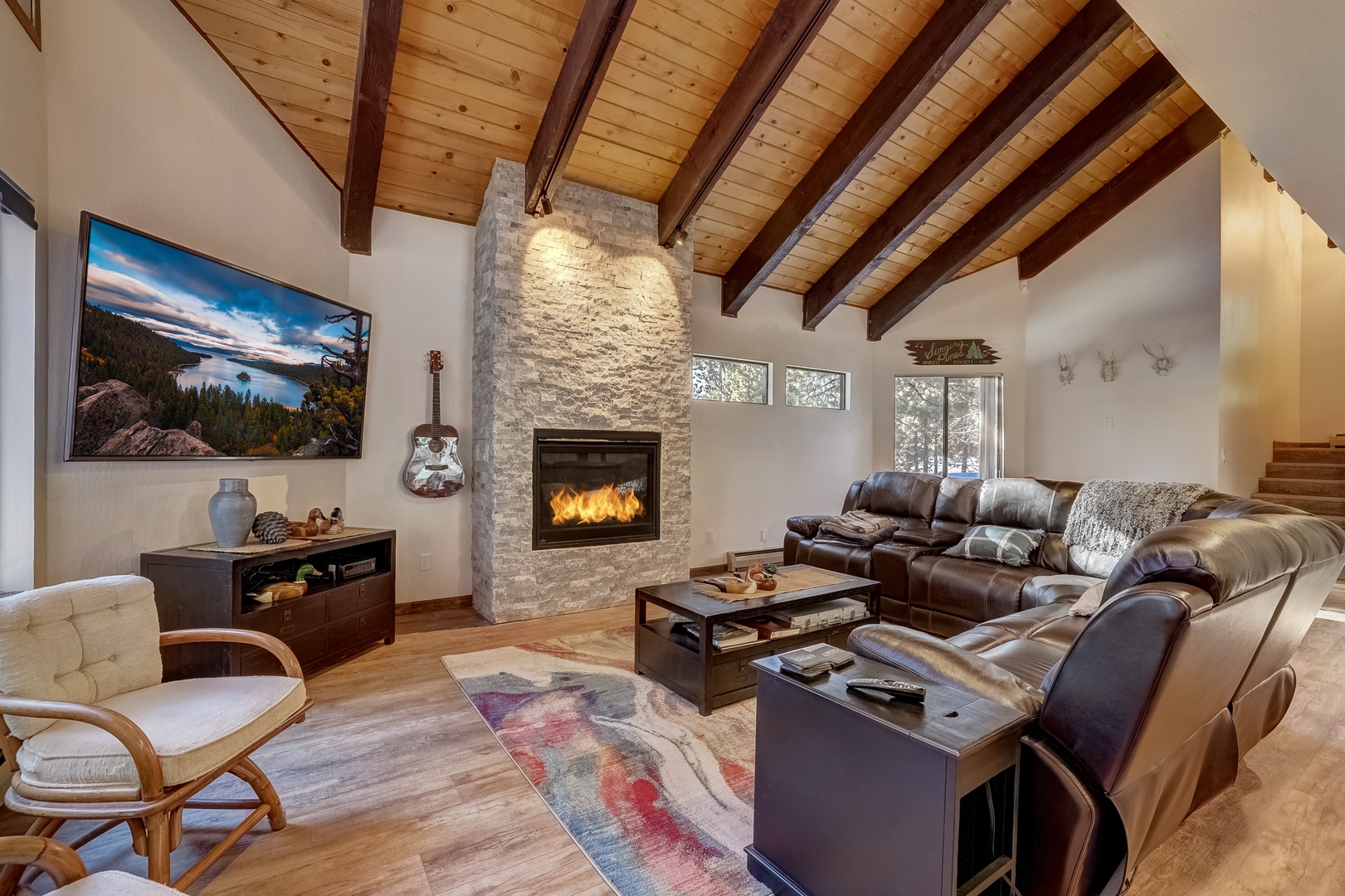 Open living space with TV, fireplace, and deck (Main floor)