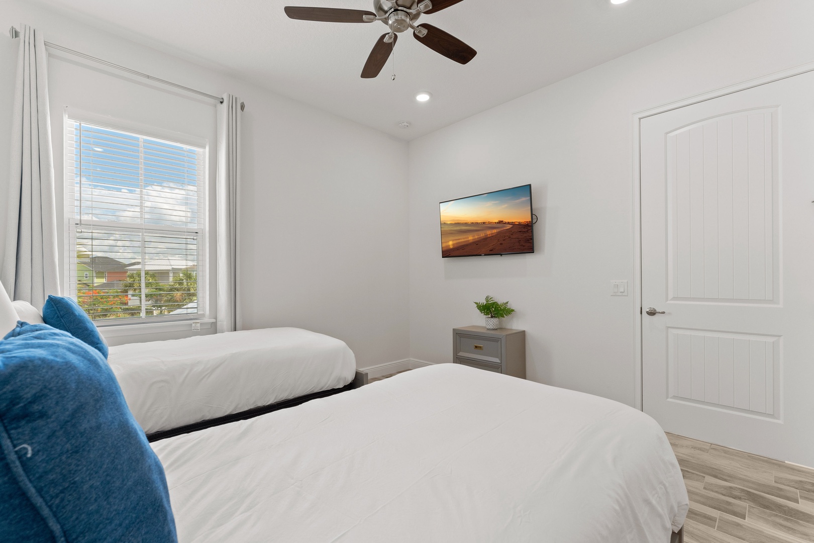 Smart TV & cozy twin beds nestled by the window, a perfect spot for lounging