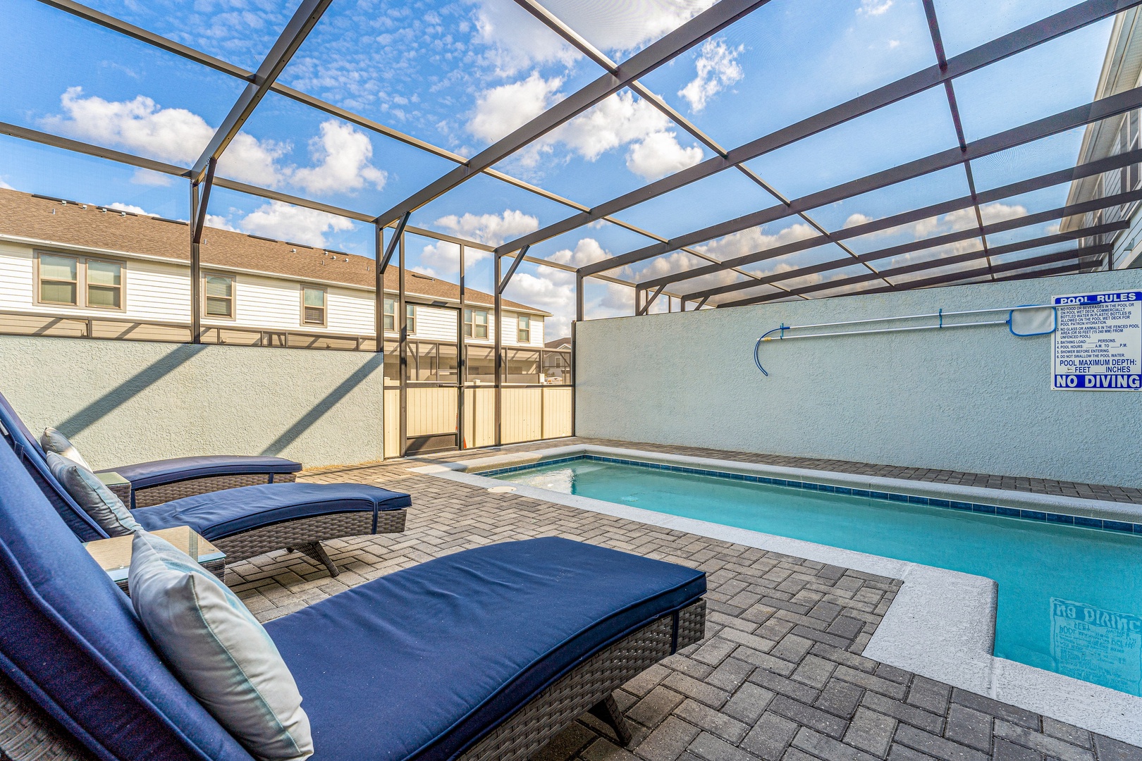 Poolside retreat under the lanai, complete with inviting lounge chairs