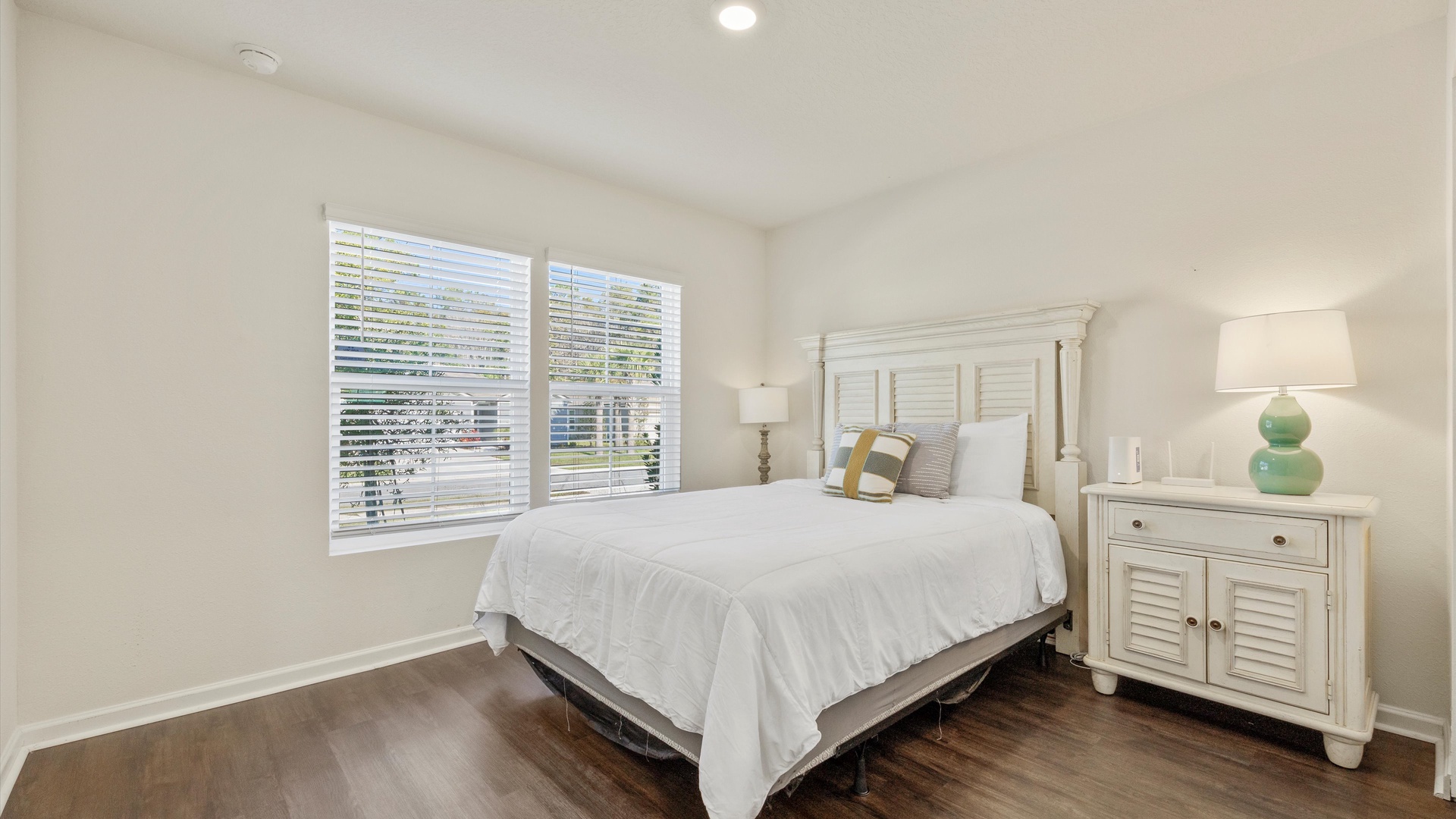 This spacious bedroom includes a queen-sized bed & Smart TV