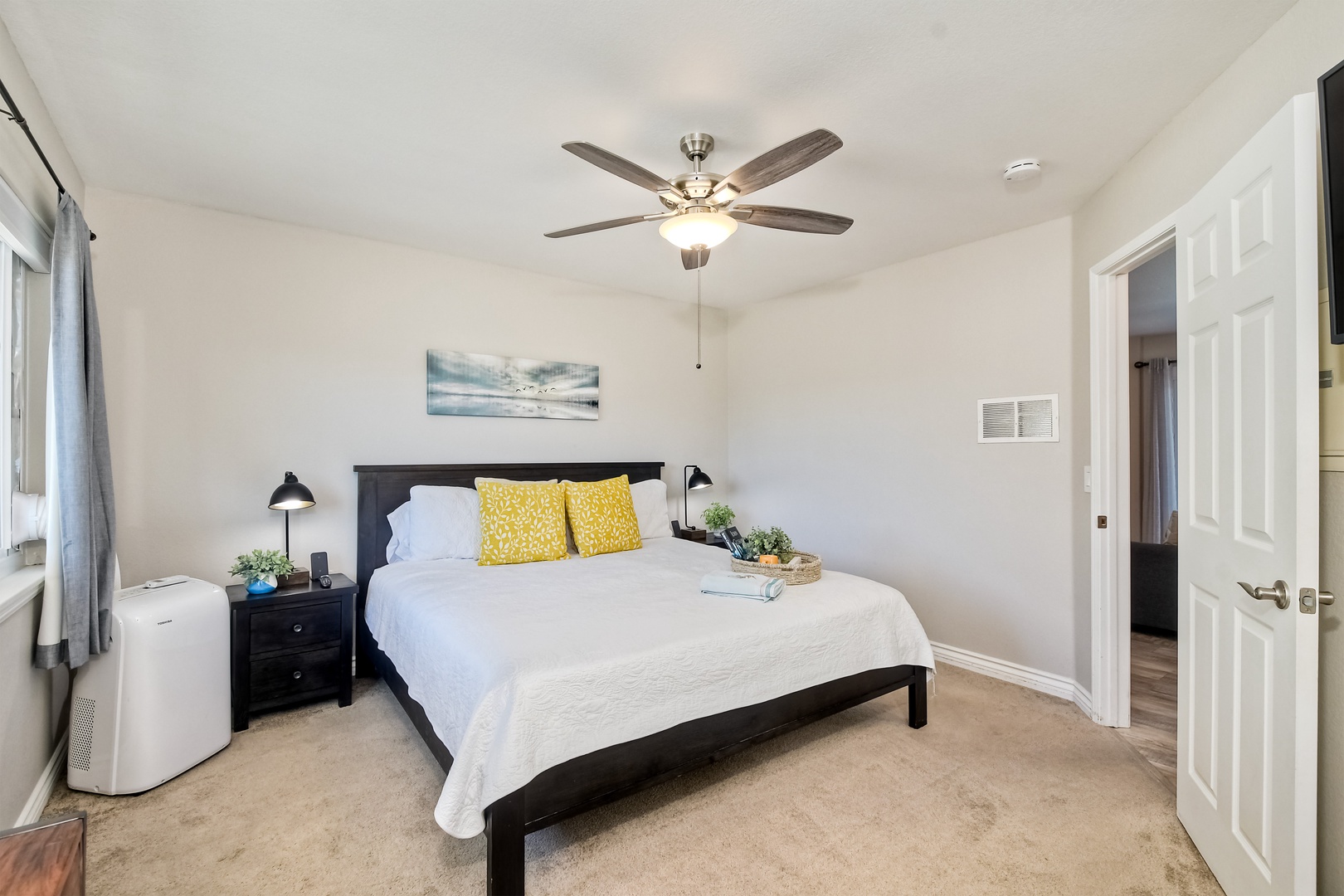 The serene primary bedroom offers a king-size bed & Smart TV