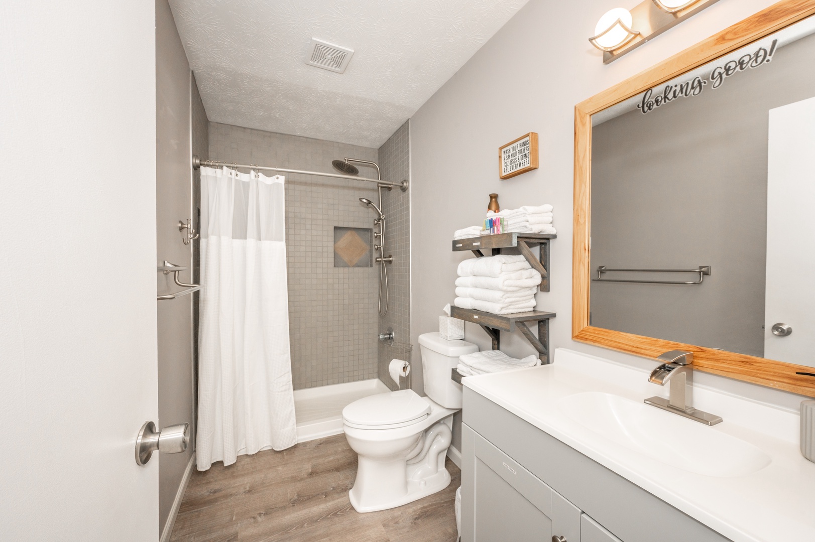 This full bath in Apartment 3 includes a single vanity & walk-in shower
