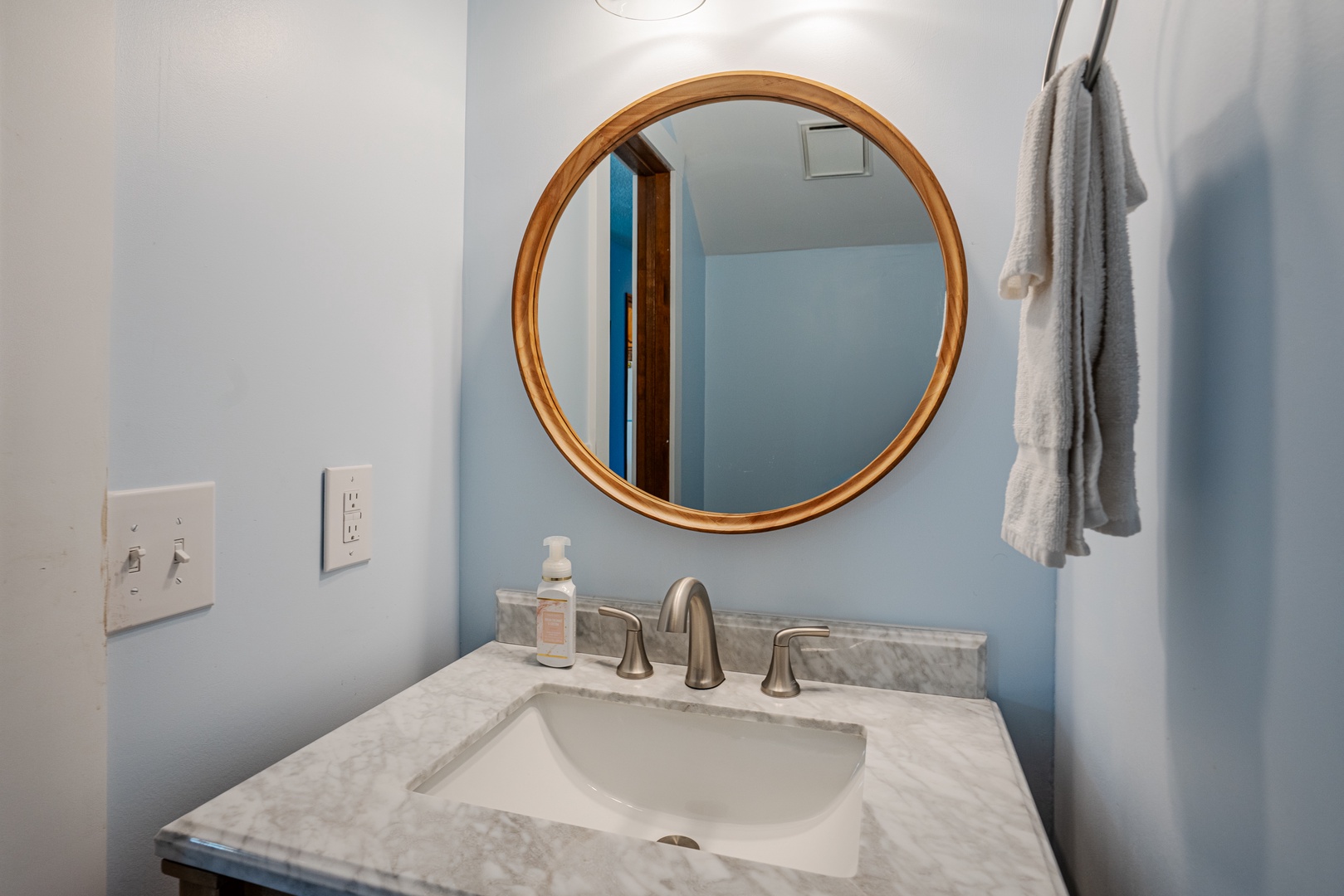 This shared half bathroom contains a single vanity