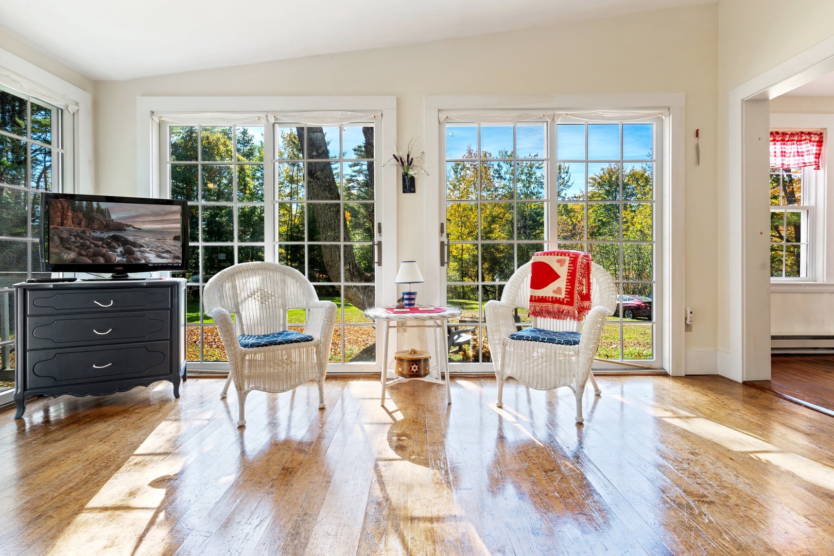 Bright living area with ample seating and Smart TV