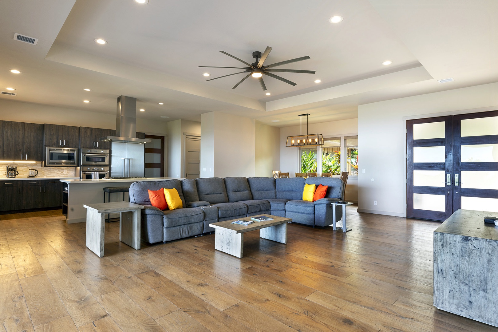 Open airy living space with sectional sofa, and TV