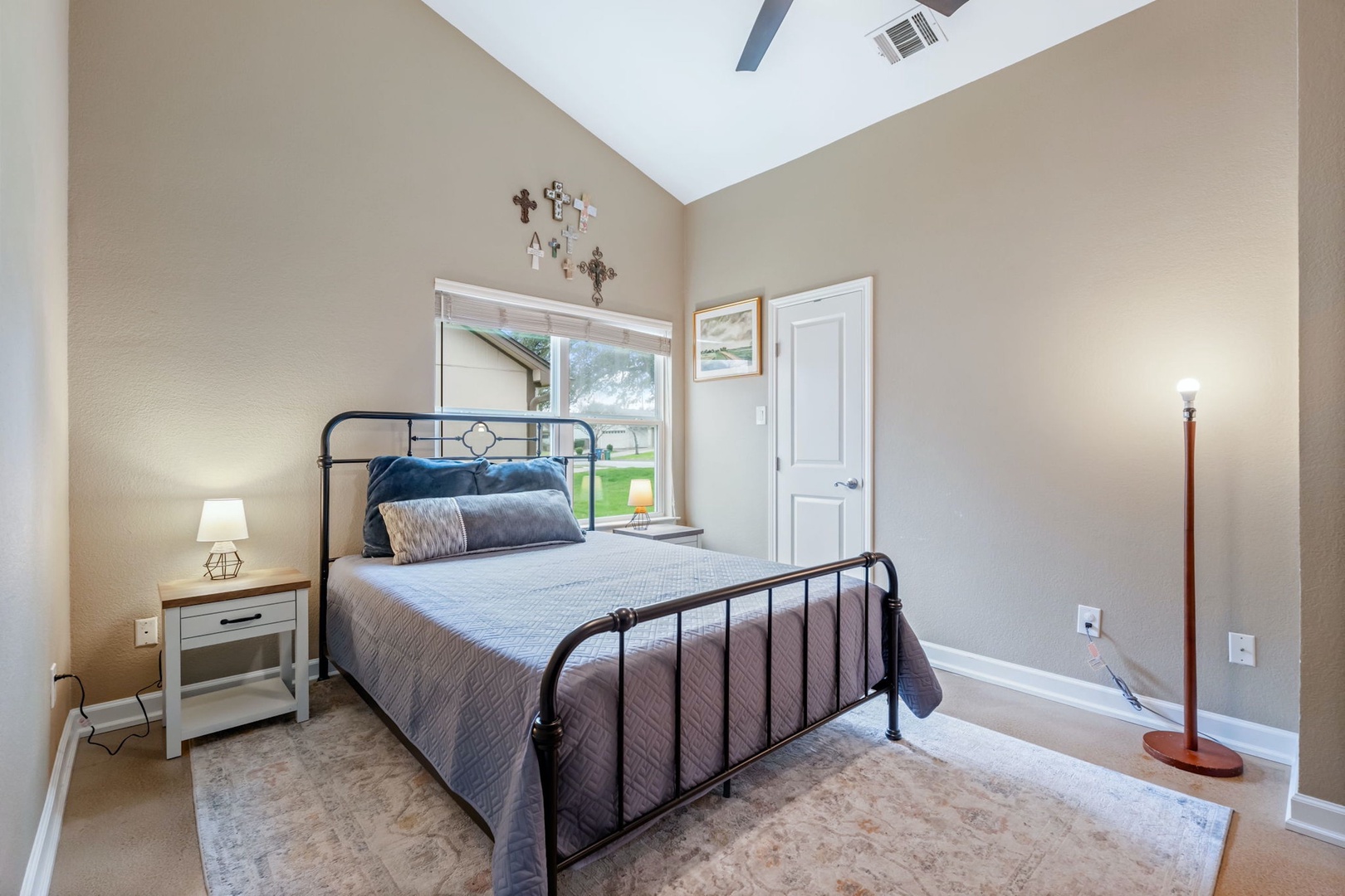 The first bedroom includes a plush queen-sized bed & Smart TV