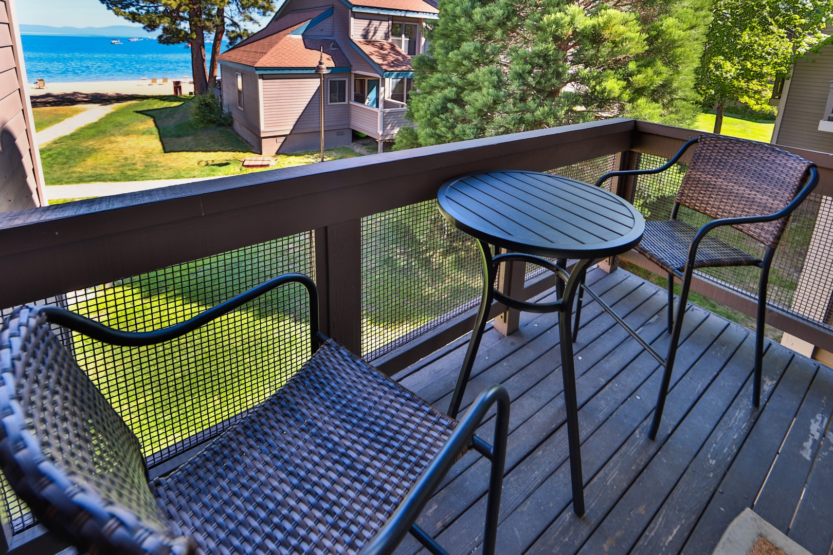 Private balcony with outdoor seating and lake view