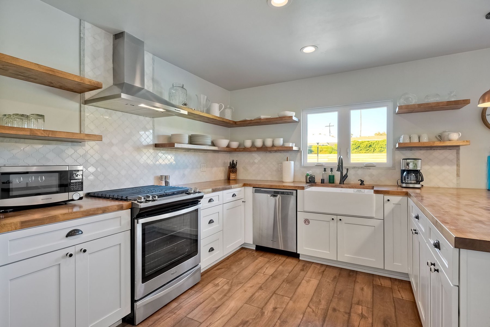 The airy kitchen is spacious & offers all the comforts of home