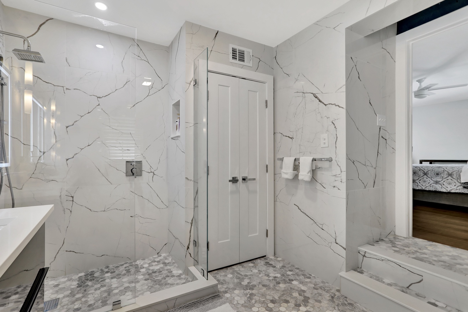 High-end finishes await in this spacious ensuite, offering a luxe glass shower