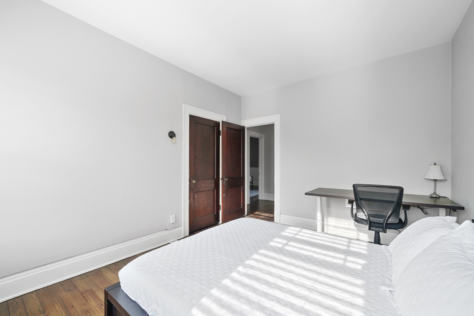 The desk workspace in this queen bedroom is ideal for catching up on emails