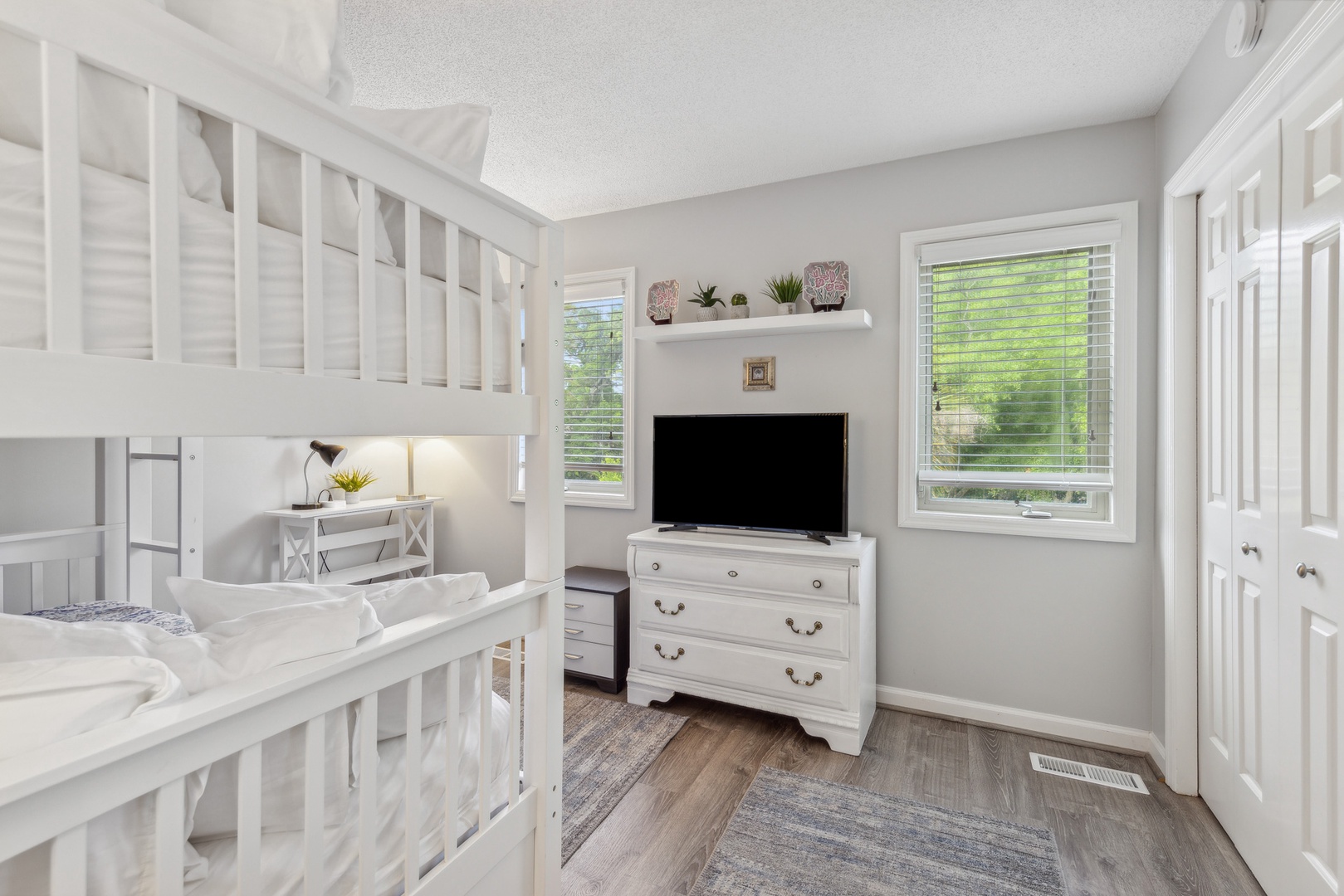 Relax in this cozy room featuring a full over full bunk bed, trundle & Smart TV