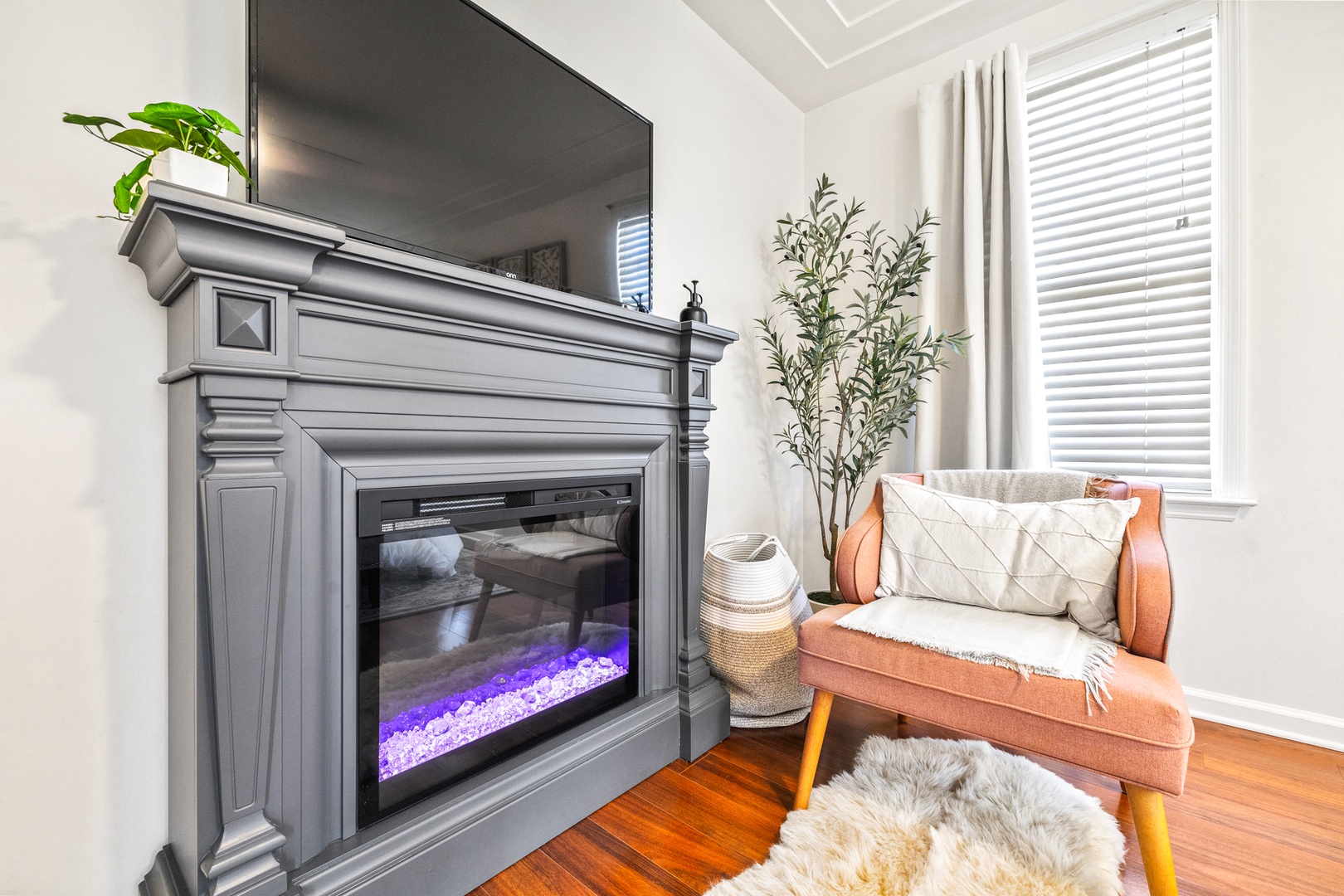 Bedroom 2 with king bed, TV, electric fireplace, and ensuite