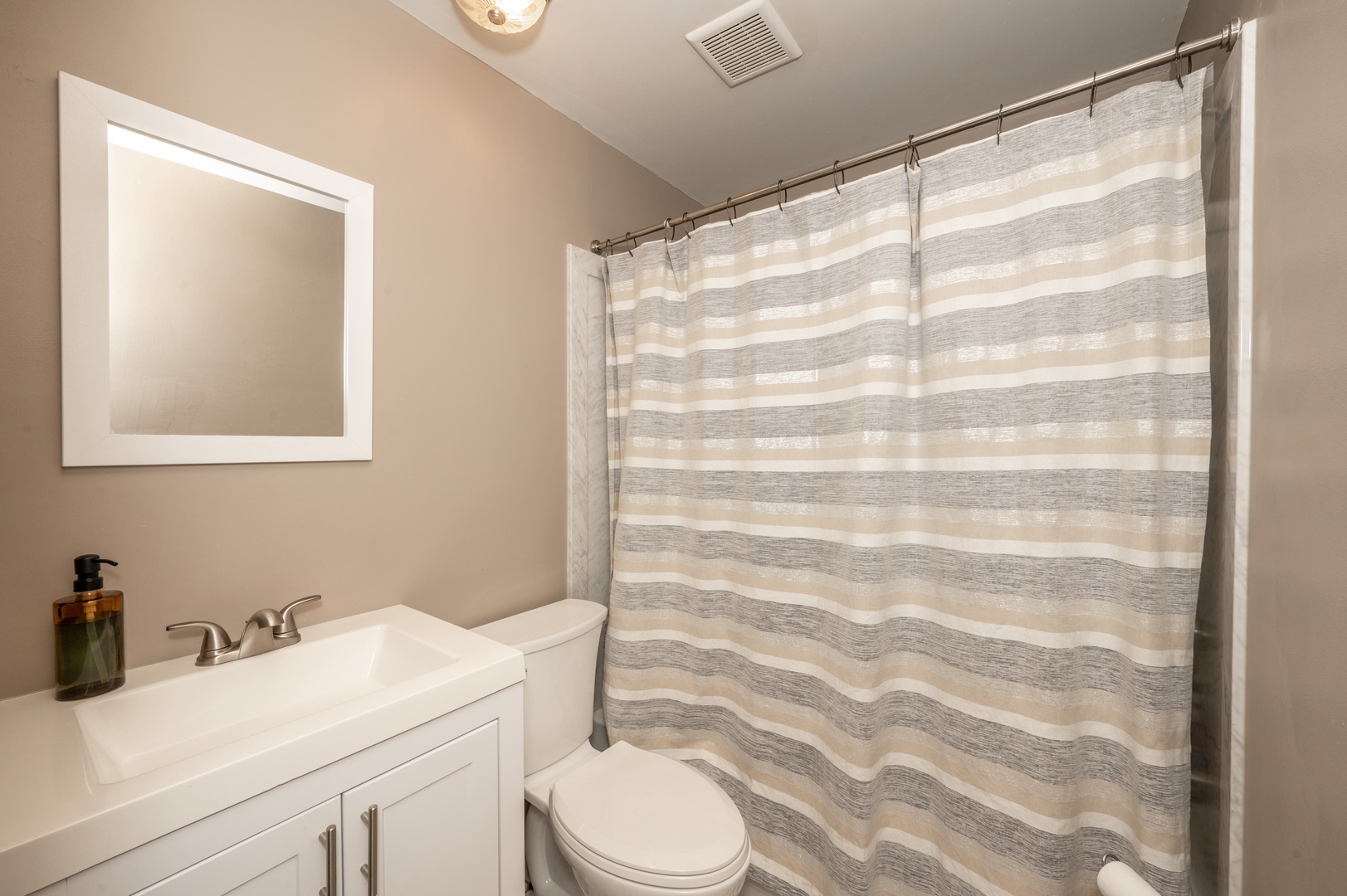 The full bathroom within Monmouth Loft 3 offers a shower/tub combo