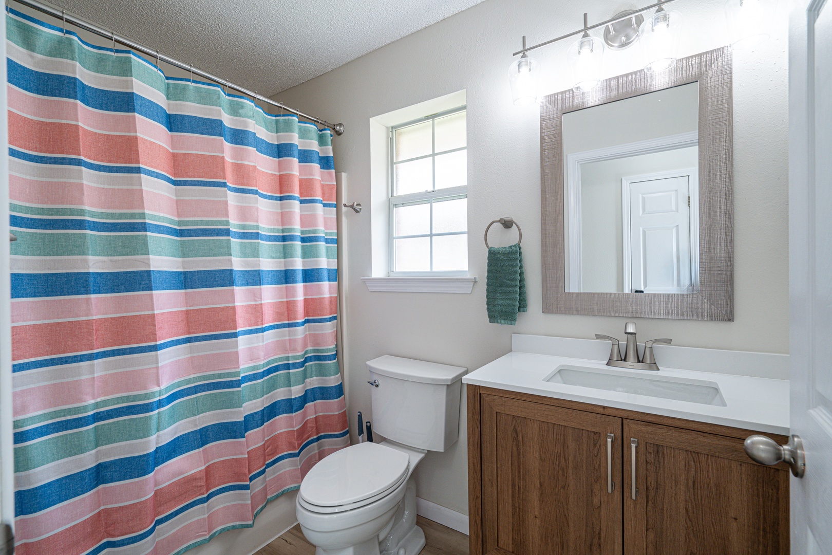 A single vanity & shower/tub combo await in the second full bath