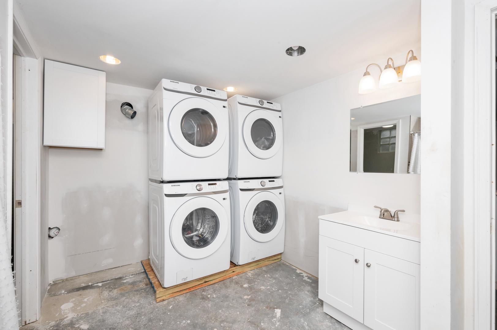 Private laundry is tucked away in the lower-level full bath, offering a shower