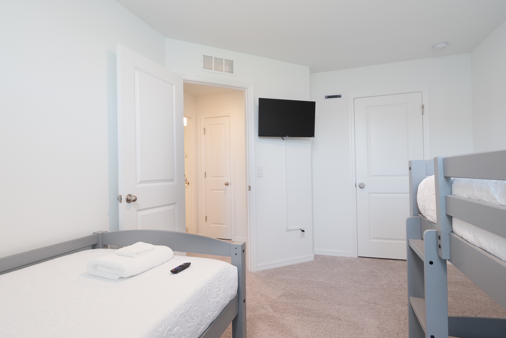 The 3rd bedroom offers a twin-over-twin bunkbed, additional twin bed, & Smart TV