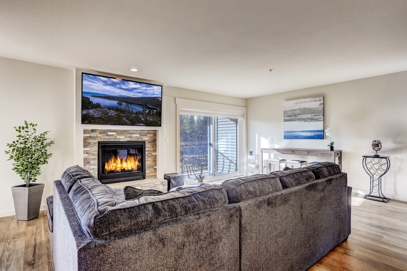 Modern living room with gas fireplace, Smart TV, and sofa sleeper