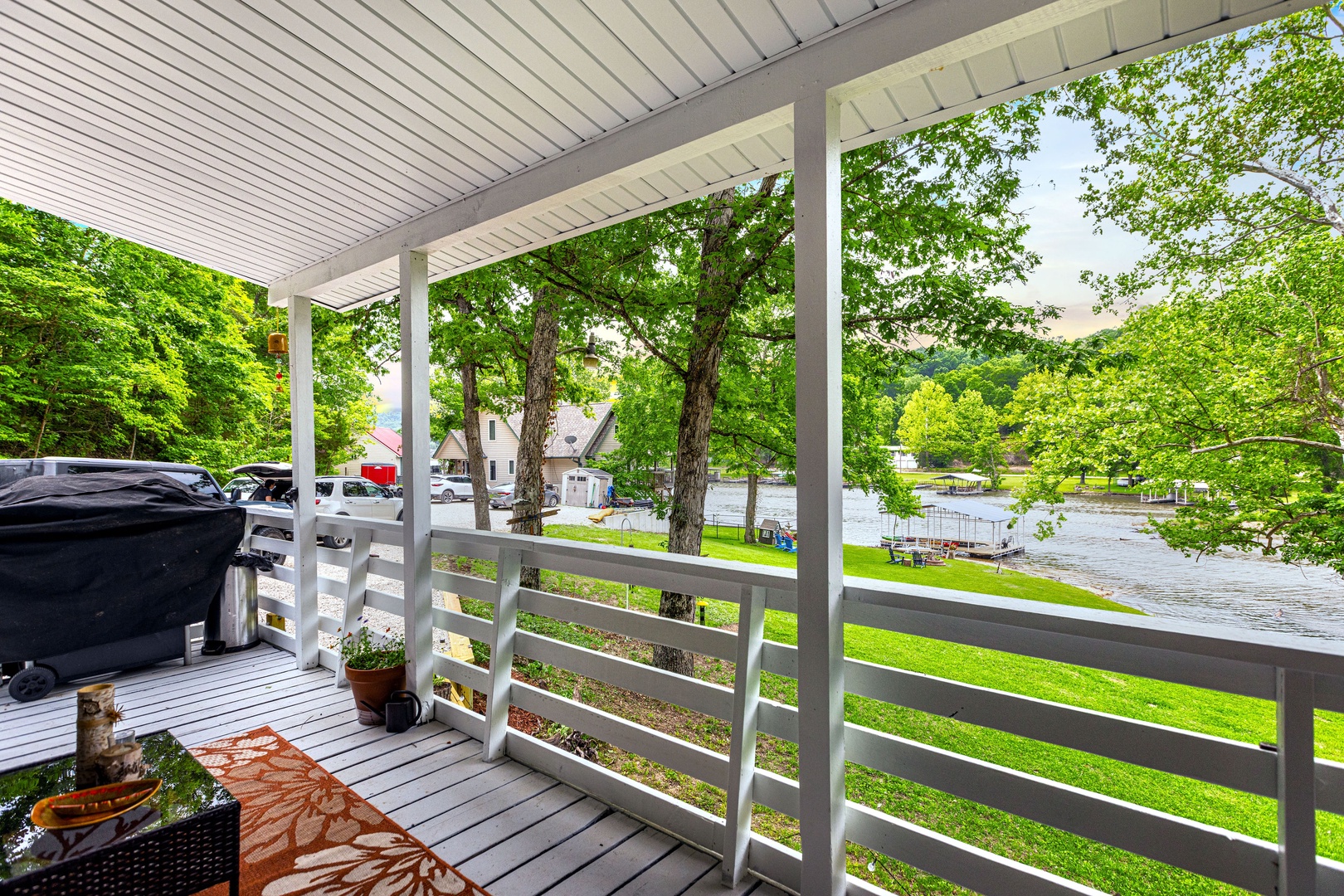 Covered porch with ample seating, grill, and breathtaking views