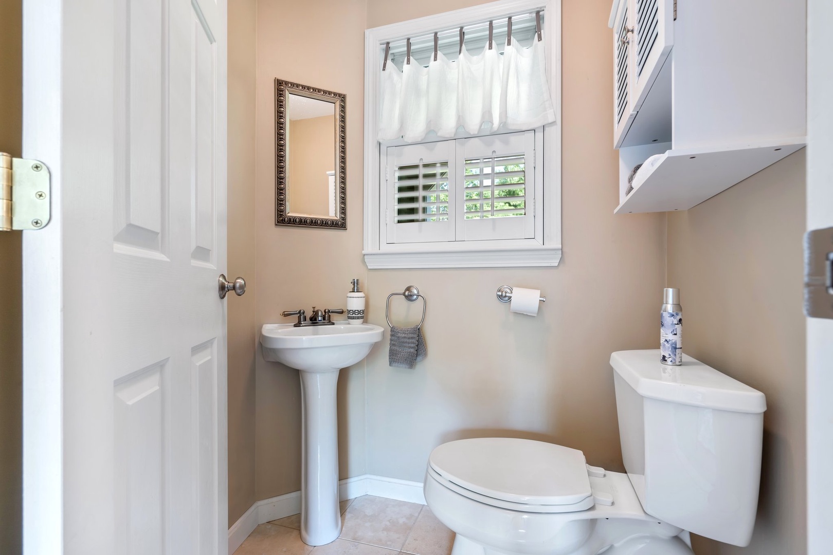 Convenient first floor half bath with a pedestal sink