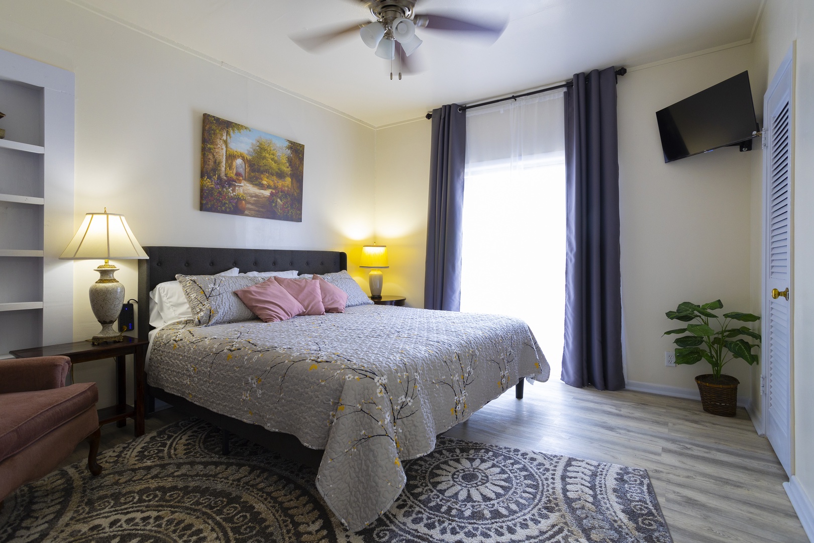 Bathed in natural light, the bedroom retreat, features a plush king bed & smart TV