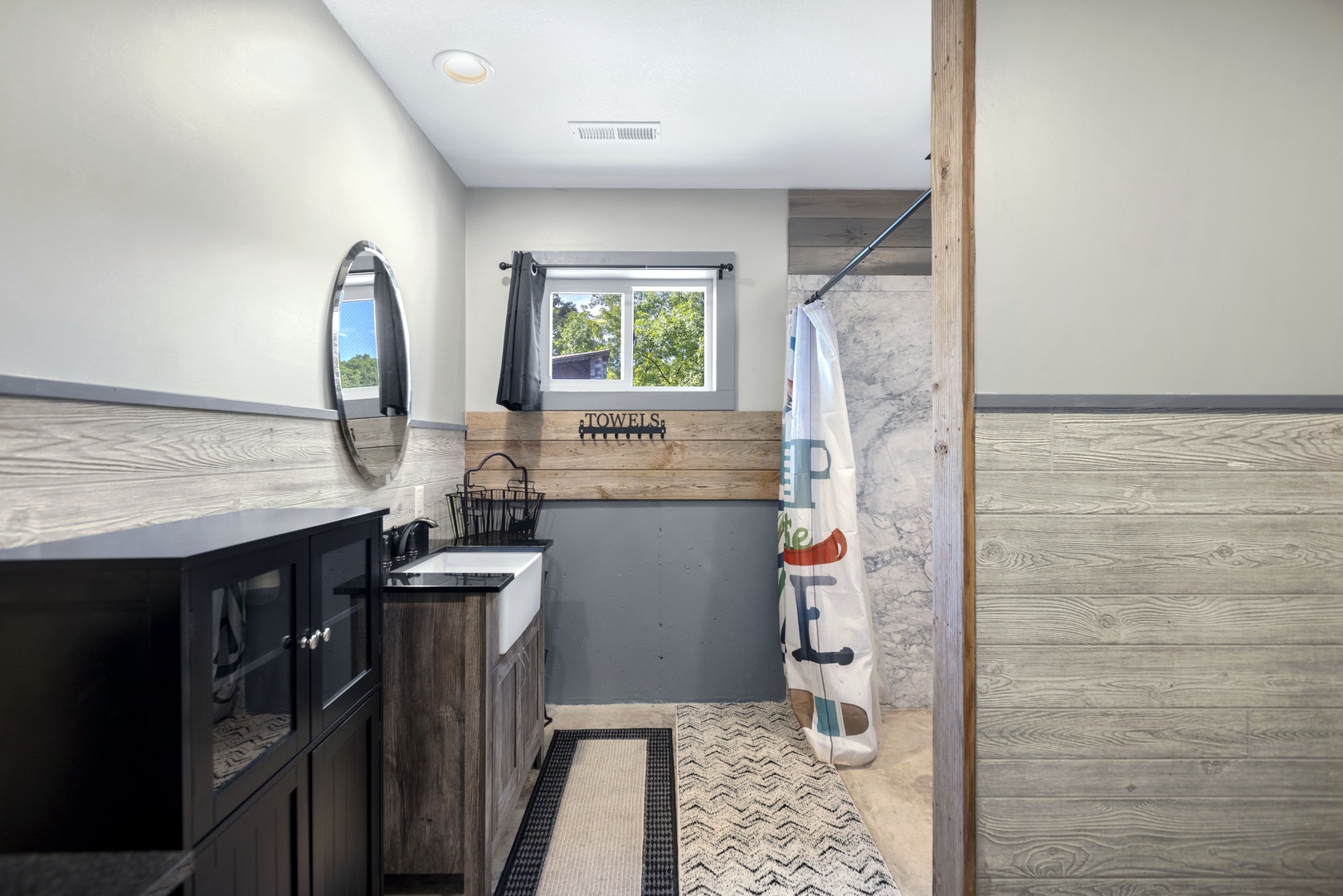 Full bathroom with dual sinks and stand up shower