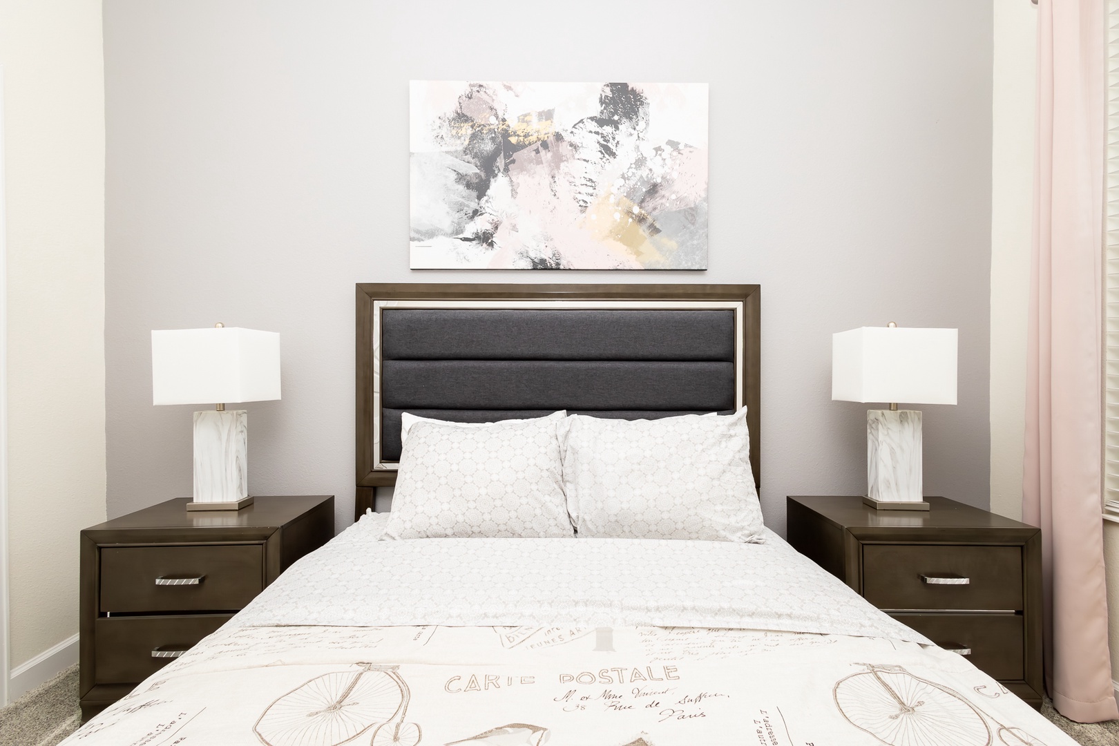 The second 1st-floor bedroom retreat features a plush queen bed & smart TV