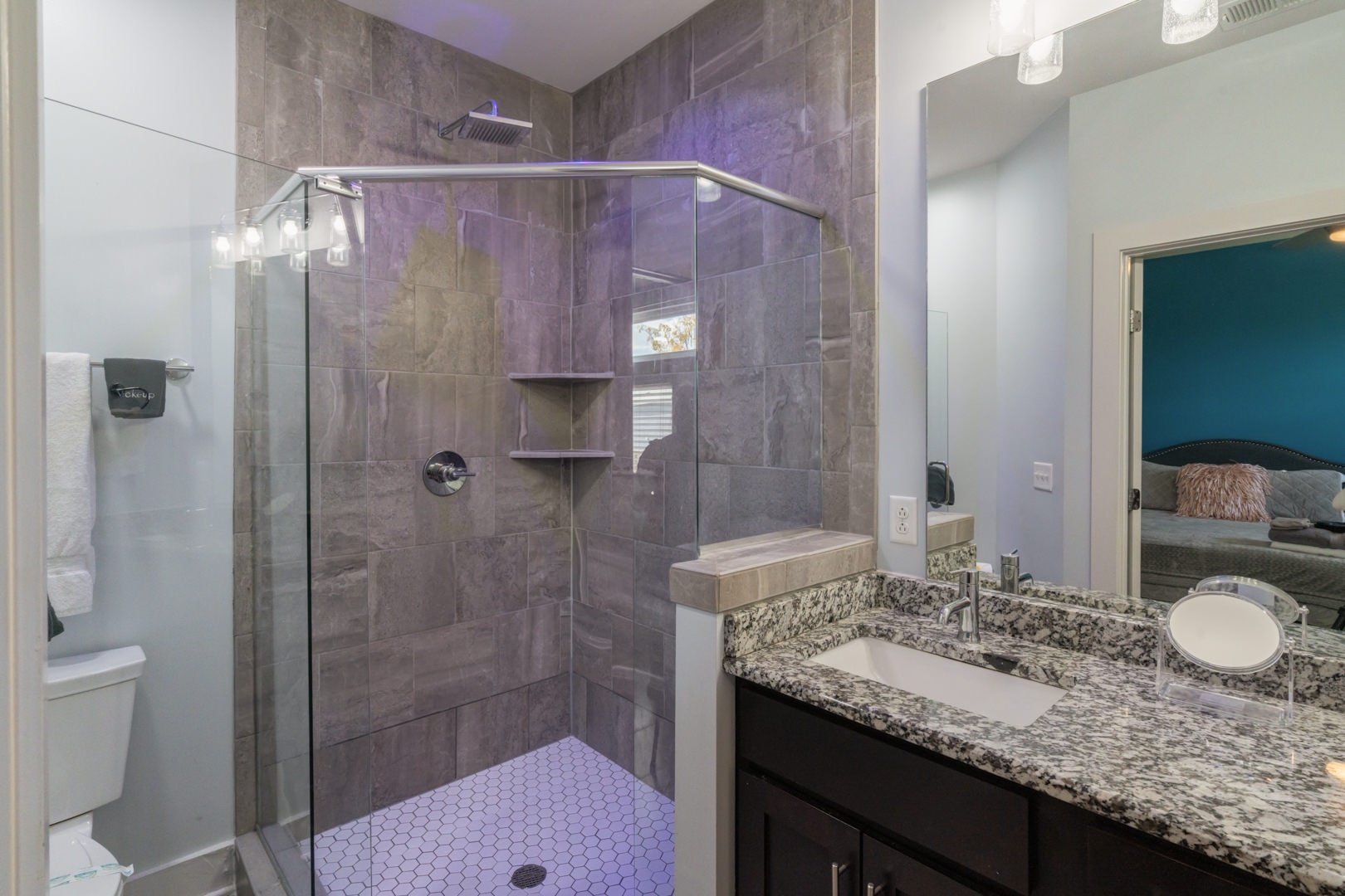 Bathroom off master bedroom with dual vanity and walk-in shower