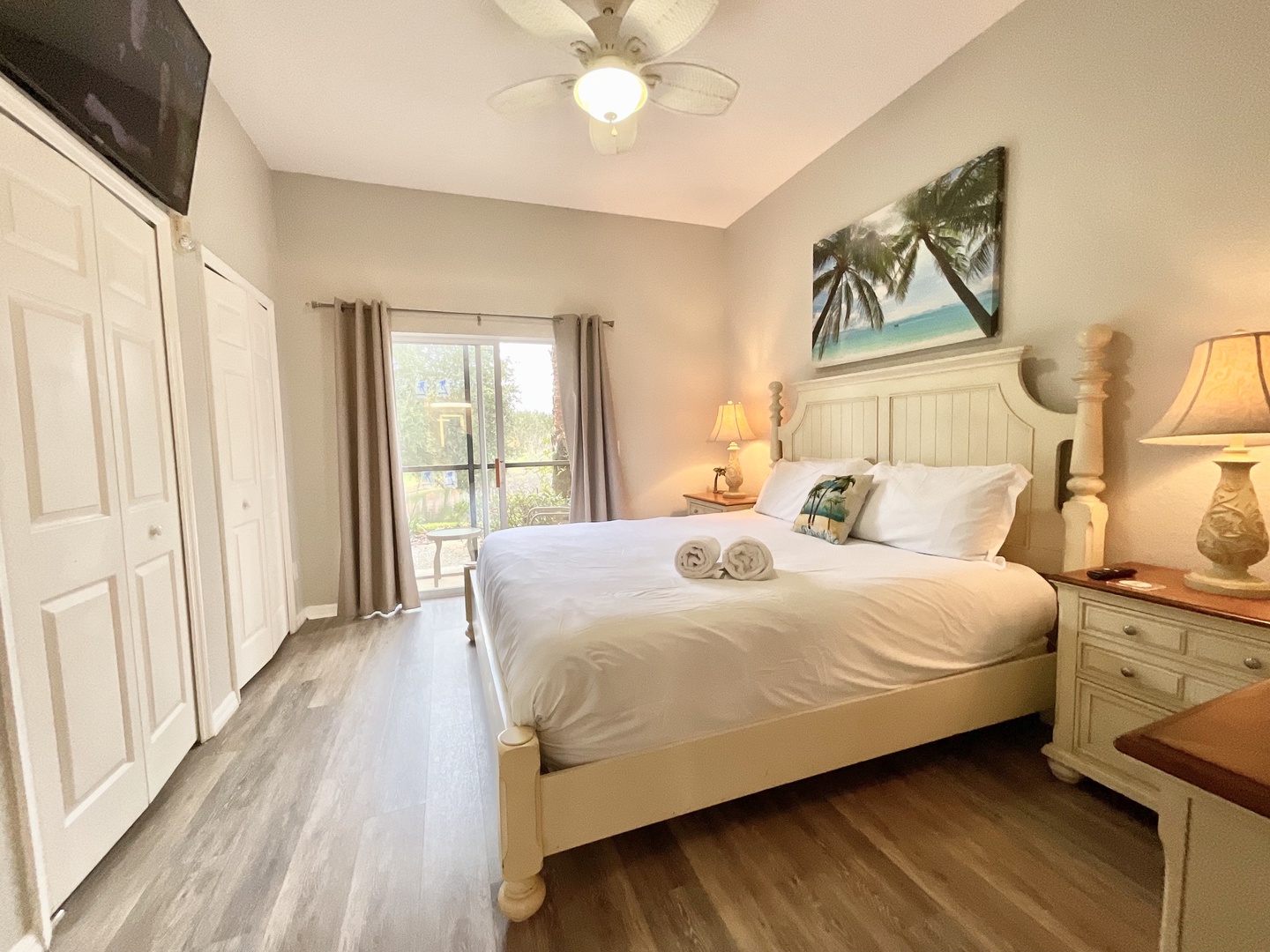 This serene king suite offers a private ensuite, patio access, & Smart TV