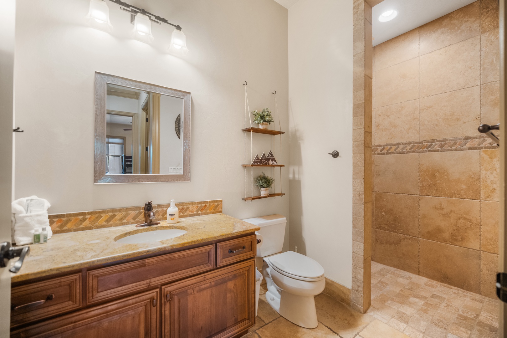 The full shared bathroom includes a single vanity & walk-in shower