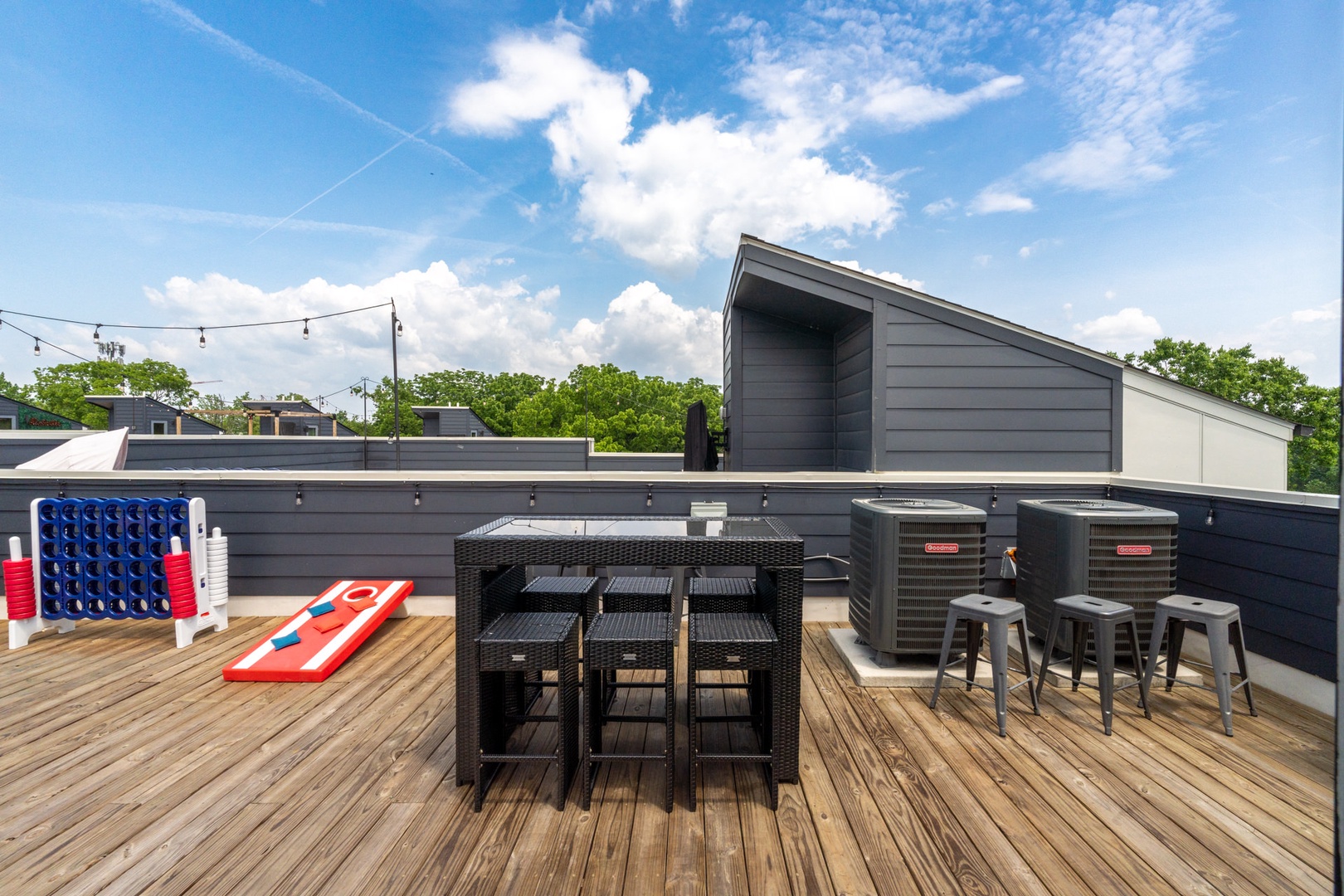 Rooftop deck with gas BBQ grill, cornhole, and ample seating
