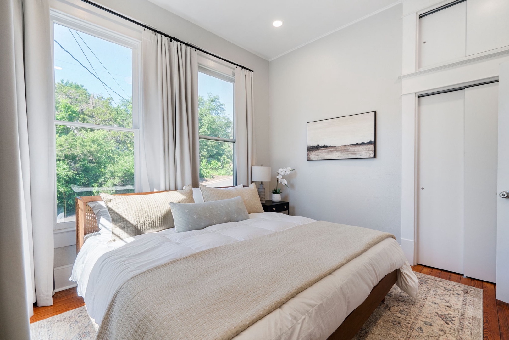 The second king bedroom showcases abundant natural light & a Smart TV