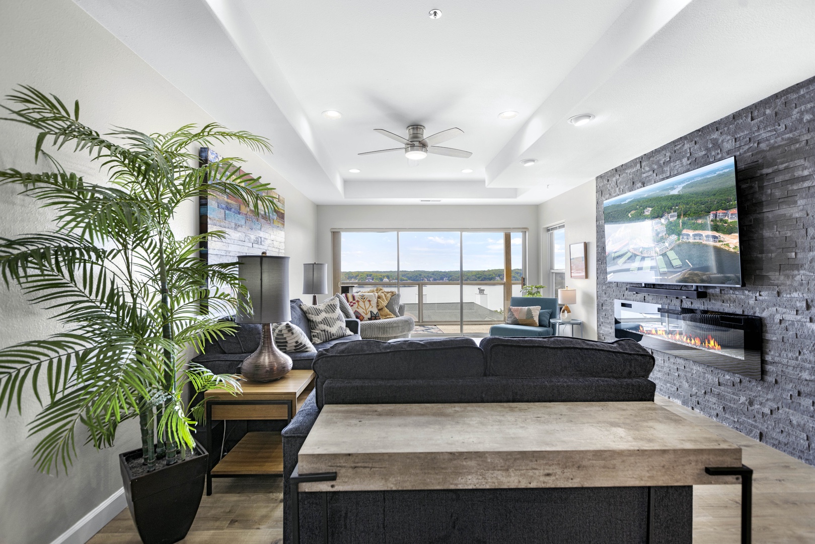 Living area with lake view, electric fireplace, sofa sleeper, and Smart TV