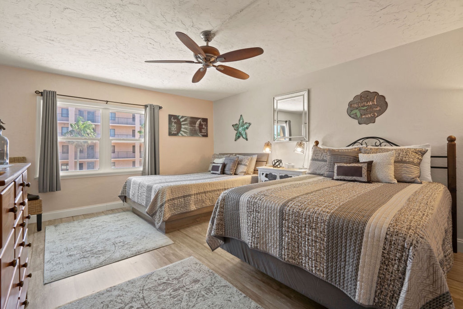 Spacious double queen bedroom with ceiling fan for added comfort